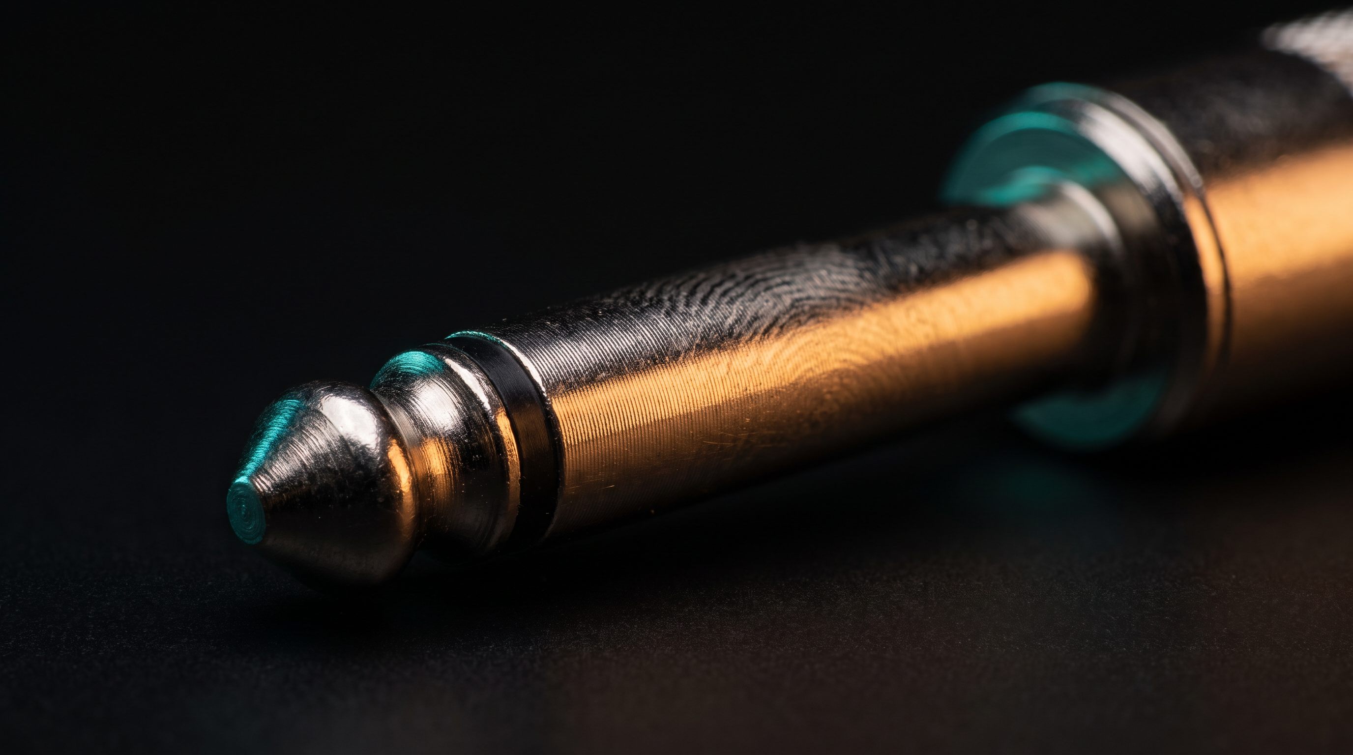 Extreme macro of a quarter-inch TS instrument plug, nickel tip and black insulating ring